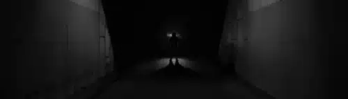 Silhouette of a person in a dark urban underpass – symbolic image for fear, deviance, and media-driven moral panics