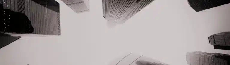Skyscrapers from below in grayscale – symbolizing market ideology, control, and the illusion of neutrality in Harcourt’s critique